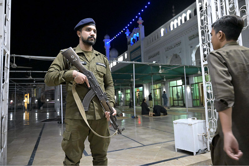 A security personnel high alert during first Tarawih people praying in congregation in Gol Chowk Masjid