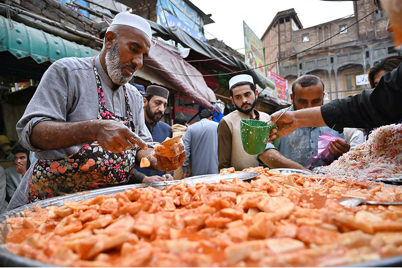 Vendor selling Kachalu Pera to the customers during first Ramzan ul Mubarak at Hashtnagri area