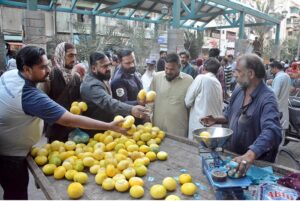 People buying fruits from a vendor on 2nd day of Ramazan at Saddar