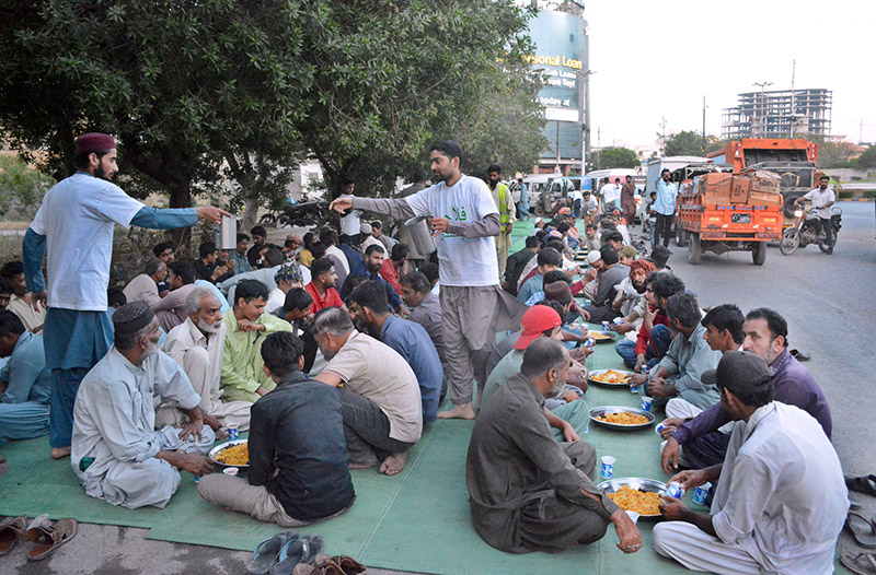 People break their fast during Iftar arranged by NGO during holy month of Ramazan at Press Club Chowrangi