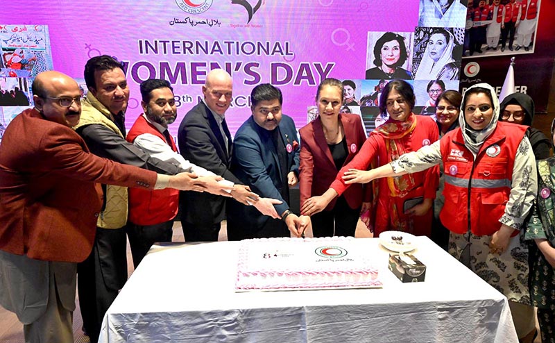 Chairman Pakistan Red Crescent Society, Sardar Shahid Ahmed Laghari and Ambassador of the Turkish Republic of Northern Cyprus in Pakistan Ms. Dilsad Senol along with the volunteers cutting cake at a seminar on International Women's Day Celebration under theme 