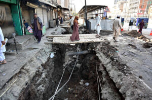 A view of the open manhole on the side of main Hashtnagri Chowk while people using temporary wooden bridge to cross the dig may cause any misshape needs the attention of concert authorities