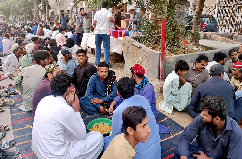 People break their fast during Iftar arranged by NGO during holy month of Ramazan at Press Club Chowrangi
