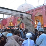 Volunteers distributing food among people during Iftari at New Memon Masjid on the first day of Ramzan