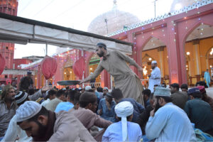 Volunteers distributing food among people during Iftari at New Memon Masjid on the first day of Ramzan