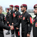Prime Minister Muhammad Shehbaz Sharif greets the paratroopers of the tri-services team who demonstrate their professional skills of Parajumping during Pakistan Day Parade 2024
