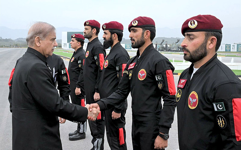 Prime Minister Muhammad Shehbaz Sharif greets the paratroopers of the tri-services team who demonstrate their professional skills of Parajumping during Pakistan Day Parade 2024