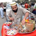 A vendor prepares Alochana Chaat at his roadside setup to attract customers.
