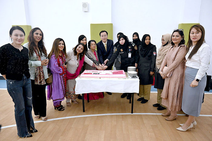 Consul General of the People's Republic of China in Karachi Mr. Yang Yundong cutting cake during International Women’s Day celebration ceremony at Consulate General of China.
