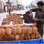 A vendor displays Dates and Coconuts to attract the customers during Holy Fasting Month of Ramzan