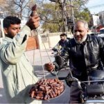 A street vendor is selling dates on the road