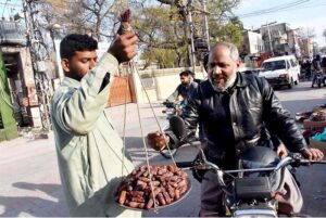 A street vendor is selling dates on the road