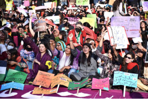 Participants displaying placards as a large women from all walks of life participating in a rally (Aurat March) to mark International Women’s Day