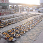 Volunteers organize Iftar for fasting people at a roadside setup arrange by philanthropists in the holy month of Ramadan