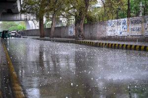 An aged man cover himself with polythene sheet to protect from rain on bicycle his way to home