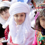 Students wearing traditional colorful dresses of Balochistan during Learning Festival 2024 at a School
