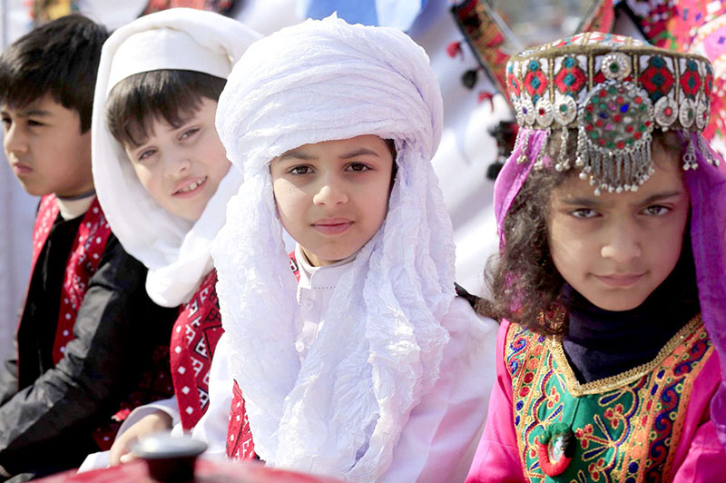 Students wearing traditional colorful dresses of Balochistan during Learning Festival 2024 at a School