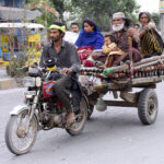 A gypsy family on motor cart migrating for new place