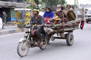 A gypsy family on motor cart migrating for new place