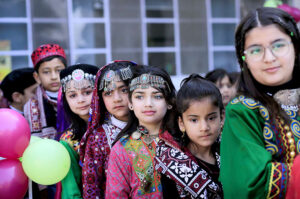 Students wearing traditional colorful dresses of Balochistan during Learning Festival 2024 at a School