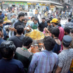 People purchasing Iftari meal from a vendor at Pakistan Chowk