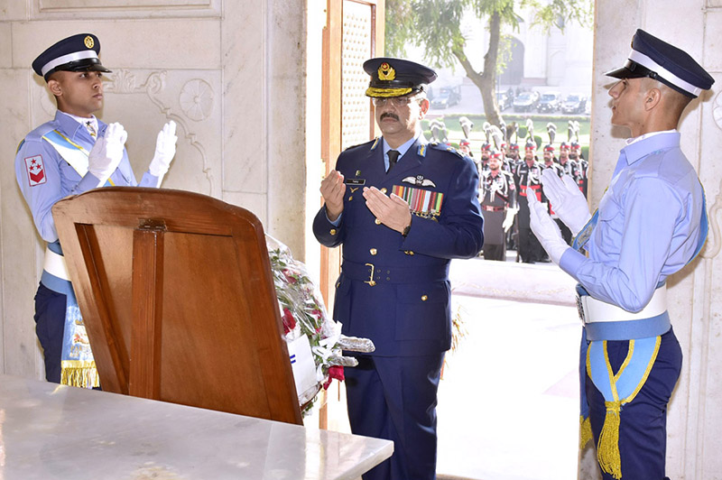 On Pakistan Day, Air Vice Marshal Tariq Mehmood Ghazi is offering Fatiha after laid floral wreath at the shrine of Allama Muhammad Iqbal
