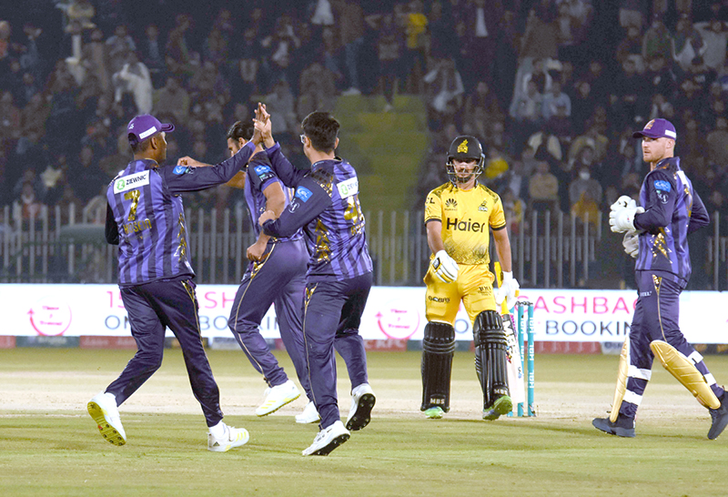 Quetta-Gladiators players celebrate the wicket of Peshawar Zalmi batter Saim Ayub during the Pakistan Super League (PSL) Twenty20 cricket match at the Rawalpindi Cricket Stadium