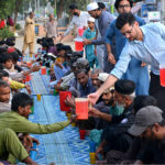Volunteers distribute drink to peoples for Ifra during the Holy Month of Ramadan at Latifabad