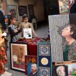 Students viewing the displayed stuff during the organized by the Farmer School System at light Door