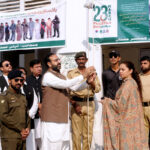 Commissioner Maryam Khan and DC Capt (retd) Rizwan Qadeer hoisting the National flag to mark the Pakistan Day ceremony at the DC office