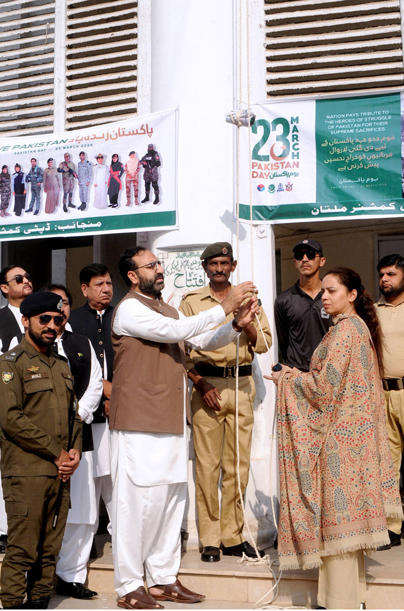 Commissioner Maryam Khan and DC Capt (retd) Rizwan Qadeer hoisting the National flag to mark the Pakistan Day ceremony at the DC office