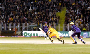 Peshawar Zalmi batter Babar Azam play a shot during the Pakistan Super League (PSL) Twenty20 cricket match at the Rawalpindi Cricket Stadium