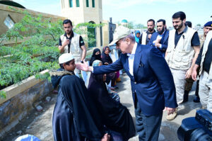 Prime Minister Muhammad Shehbaz Sharif consoling the affectees of torrential rains at a relief camp