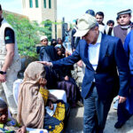 Prime Minister Muhammad Shehbaz Sharif consoling the affectees of torrential rains at a relief camp