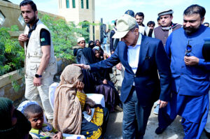 Prime Minister Muhammad Shehbaz Sharif consoling the affectees of torrential rains at a relief camp