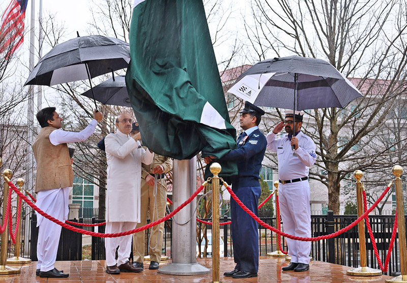 Ambassador Masood Khan hoisting national flag on Pakistan Dayat the Embassy of Pakistan