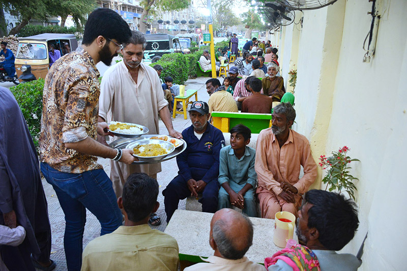 Volunteers distribute food among the people in fast during the Holy Month of Ramadan at Hussainabad