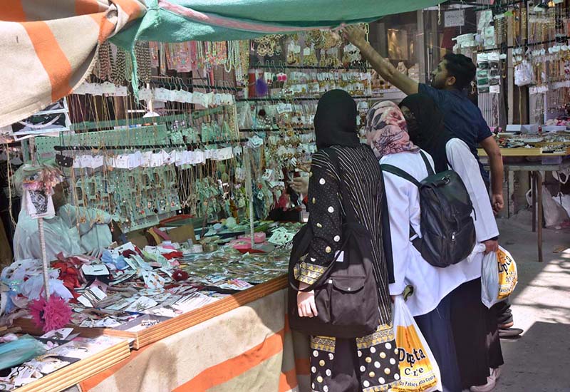 Women purchasing artificial jewelry from a roadside stall for Eid ul Fitr Festival