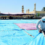 Workers busy installing tent for Namaz e Eid ul Fitr at Markazi EidGah