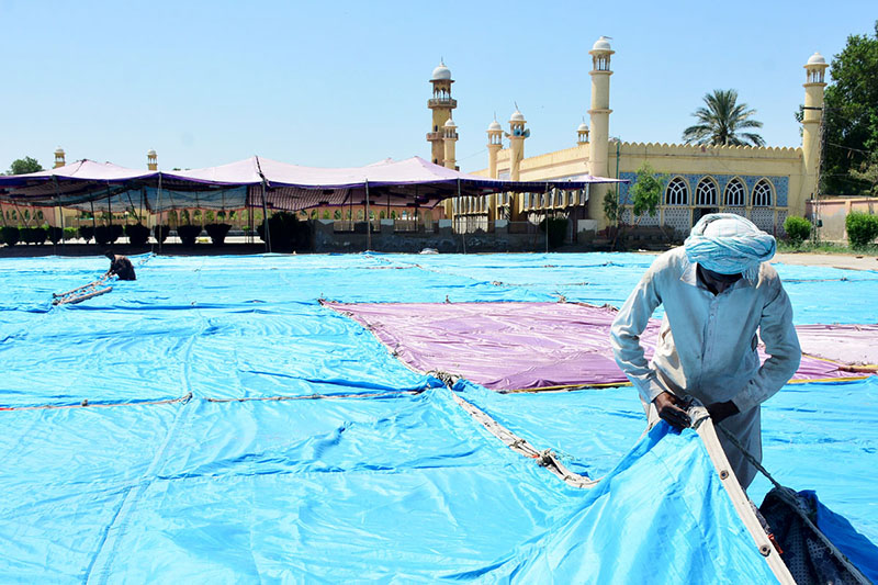 Workers busy installing tent for Namaz e Eid ul Fitr at Markazi EidGah
