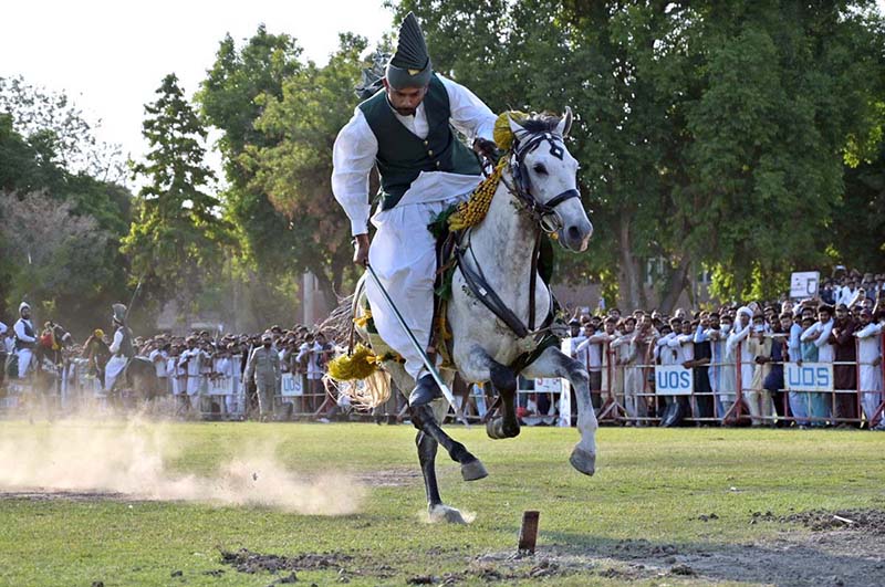 Horse rider participating in Tent-Pegging competition during opening ceremony of annual Sports Gala of University of Sargodha.