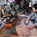 Tailors are busy in stitching clothes at their workplace in Islampura in connection with upcoming Eidul Fitr