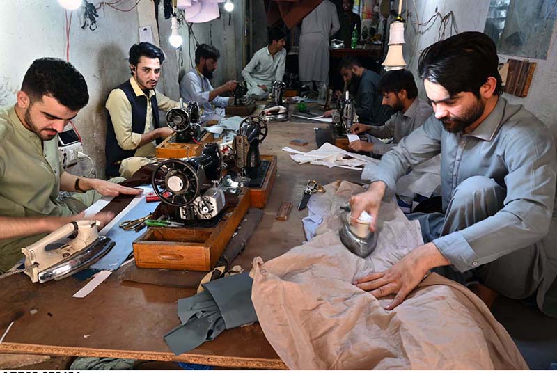 Tailors are busy in stitching clothes at their workplace in Islampura in connection with upcoming Eidul Fitr