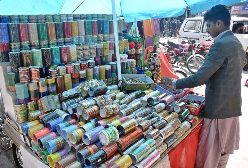 Women purchasing artificial jewelry from a roadside stall for Eid ul Fitr Festival