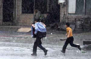 A motorcyclist on the way while cover himself with plastic sheet to protect from during rain that experienced the Twin Cities.