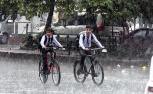 A motorcyclist on the way while cover himself with plastic sheet to protect from during rain that experienced the Twin Cities.