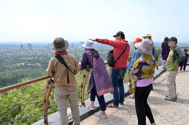 Foreigners enjoy bird eye view of the federal capital from the picnic point Daman e Koh.
