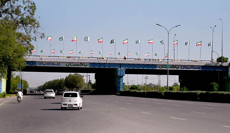Pakistan and Iran National Flags adorn on bridge in Federal Capital ahead of the Iranian President's state visit