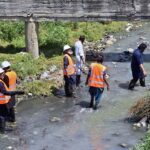 CDA workers busy in cleaning the nullah along Srinagar Highway.