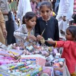 Young girls are busy in selecting bangles from a stall at Urdu Bazaar in connection with upcoming Eidul Fitr.